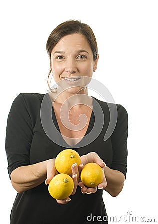 Woman offering fresh lemons Stock Photo