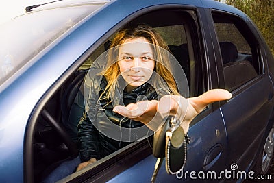 Woman offering keys to new car Stock Photo