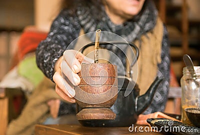 Woman offering yerba mate drink Stock Photo