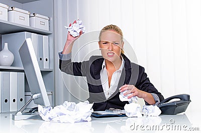 Woman in office with crumpled paper Stock Photo