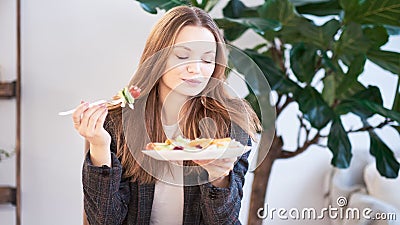 Woman in office eating salad at working place. Concept of lunch at work and eating healthy food. healthy eating concept Stock Photo