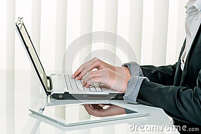 Woman in office with laptop computer com Stock Photo