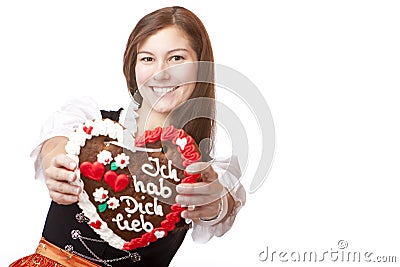 Woman in Oktoberfest dirndl holds heart Stock Photo