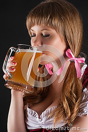 Woman Oktoberfest drinks beer Stock Photo