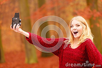 Woman with old vintage camera taking selfie photo. Stock Photo