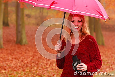 Woman with old vintage camera and umbrella. Stock Photo