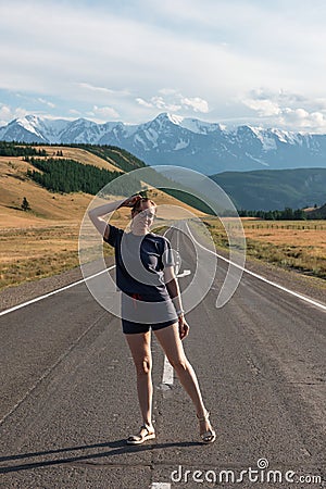 Woman om the Chuysky trakt road in the Altai mountains. Stock Photo