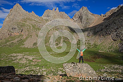 woman open arms on high altitude mountain Stock Photo