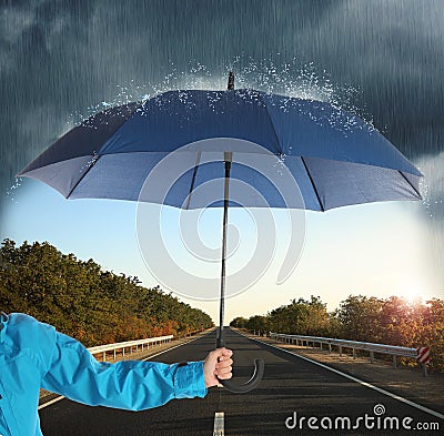 Woman with open blue umbrella on empty asphalt road, closeup Stock Photo