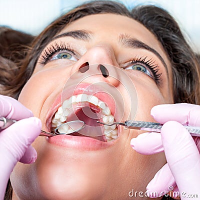 Woman with open mouth at dental check up Stock Photo