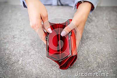 Woman opening completely empty wallet Stock Photo