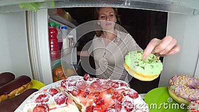 Woman opens the refrigerator at night. night hunger. diet gluttony Stock Photo