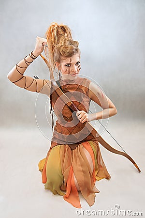 Woman in orange and brown outfit, warrior, fashion, studio Stock Photo