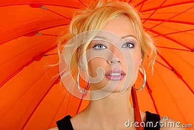 Woman with orange umbrella Stock Photo