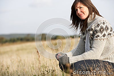 Woman Outdoors In Autumn Landscape Stock Photo