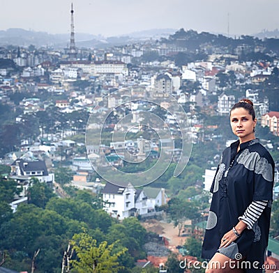 Woman overlooking the city view, Dalat, Vietnam Stock Photo