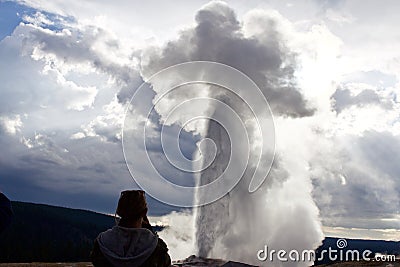 Woman overlooks Old Faithful Geyser Editorial Stock Photo