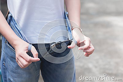 Woman in oversize jeans showing how much weight lost. Diet fat weight loss Healthy lifestyles concept. Stock Photo