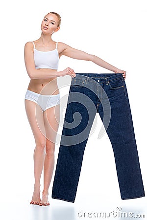 Woman with oversized jeans Stock Photo