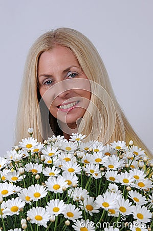 Woman with oxeye daisy flowers Stock Photo