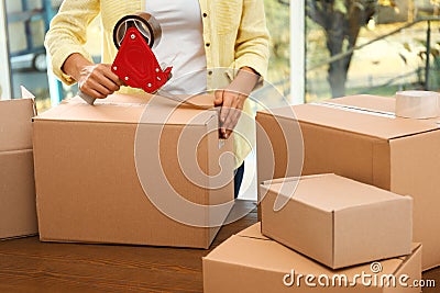 Woman packing box indoors. Moving day Stock Photo