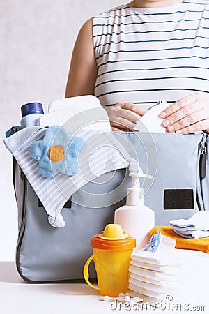 Woman packing diaper bag in maternity hospital. Stock Photo