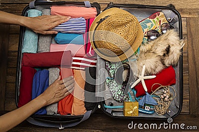 Woman packing a luggage for a new journey Stock Photo