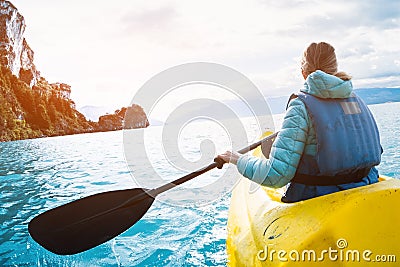 Woman paddles kayak Stock Photo