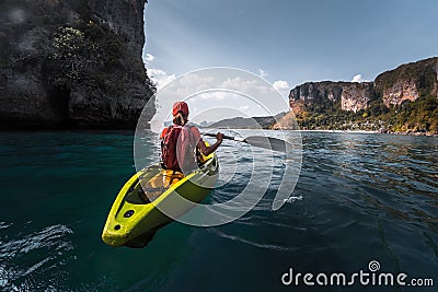 Woman paddles kayak Stock Photo