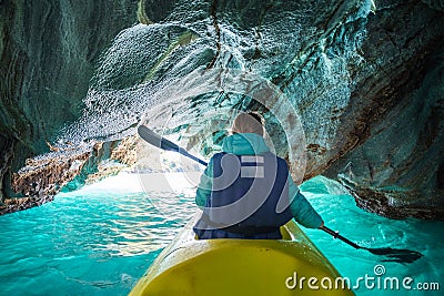 Woman paddles kayak Stock Photo