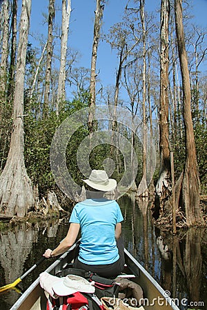 Woman Paddling a Canoe - Okefenokee Swamp Stock Photo