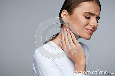 Woman In Pain. Beautiful Girl Feeling Toothache, Jaw, Neck Pain Stock Photo