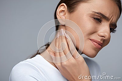 Woman In Pain. Beautiful Girl Feeling Toothache, Jaw, Neck Pain Stock Photo