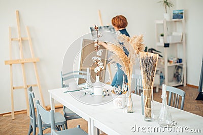 Woman painter preparaing class for work Artist modern studio interior. Stock Photo
