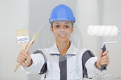 Woman painter showing brushes Stock Photo