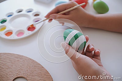 Woman painting Easter eggs at home. family preparing for Easter. Stock Photo