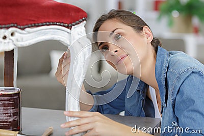 Woman painting renewing chair at home Stock Photo