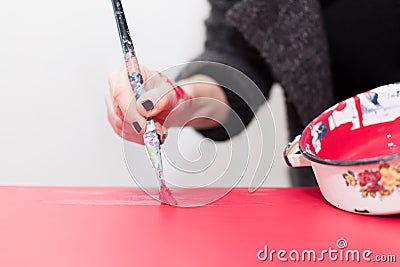 Woman painting table Stock Photo