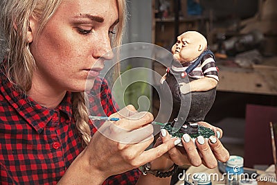 Woman paints a little plump little man Stock Photo