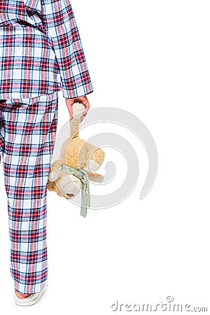 Woman in pajamas with a bear plush, space on the right Stock Photo