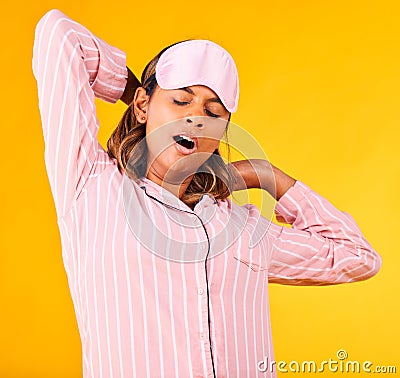 Woman, pajamas and yawn with stretch in studio for sleep or peaceful for stress, tired or sad for burnout. Female model Stock Photo