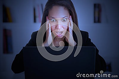 Woman in Panic Looking At A Computer Monitor Stock Photo