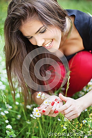 Woman in park gather spring flowers Stock Photo