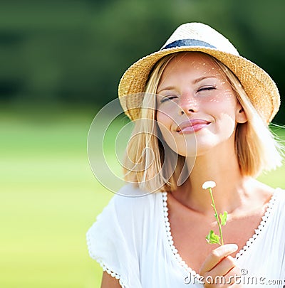 Woman, park and peace with thinking, flower and eyes closed with peace, relax and memory outdoor in summer. Girl, garden Stock Photo