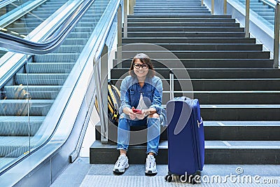 Woman passenger tourist at station with luggage Stock Photo