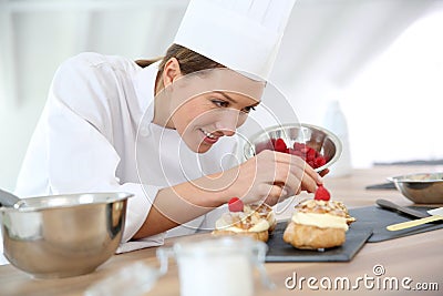 Woman pastry chef preparing desert Stock Photo