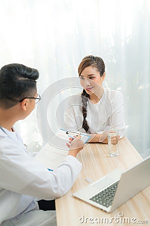 Woman patient consulting with doctor or psychiatrist on obstetric - gynaecological female illness, or mental health in medical Stock Photo