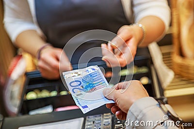 Woman is paying In cash with euro banknotes Stock Photo