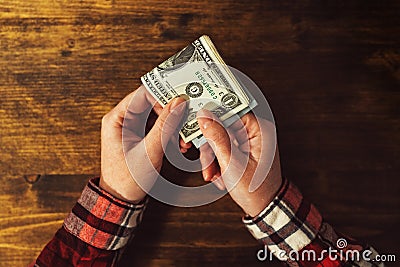 Woman paying with USA dollar money banknotes Stock Photo