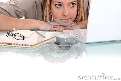 Woman peering at her laptop Stock Photo